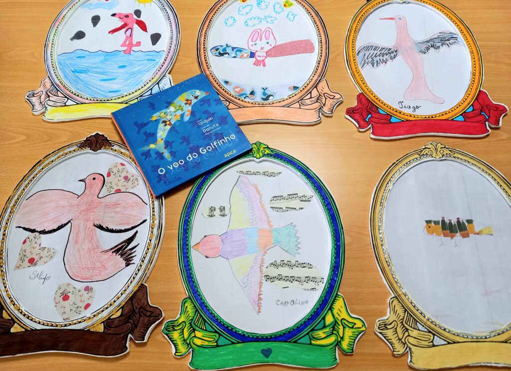 Os vários pássaros de sonho emoldurados com o livro de Ondjaki, "O voo do golfinho".